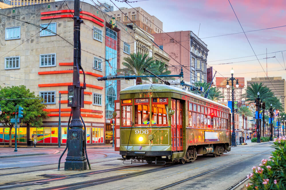 A city tram can be seen, which is a budget-friendly means of transportation in New Orleans.
